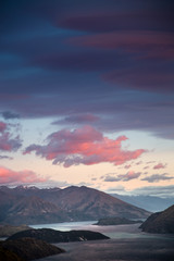 Fototapeta na wymiar Sunrise sky mountain landscape. Early dawn morning colorful sky with scenic view over mountains in New Zealand. Roys Peak Wanaka