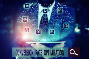 Conceptual hand writing showing Conversion Rate Optimization. Concept meaning system for increasing percentage of visitors Male wear formal work suit presenting presentation smart device
