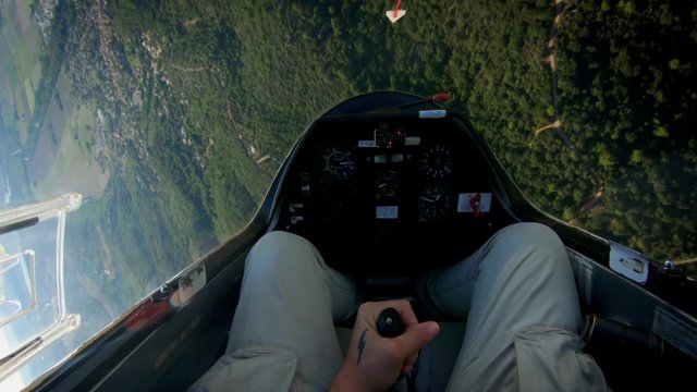 POV of pilot flying small private jet or glider