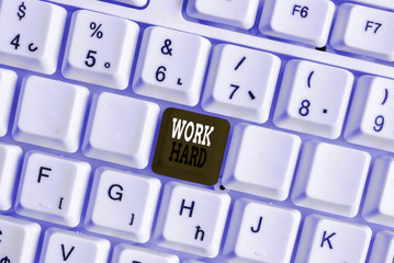Word writing text Work Hard. Business photo showcasing Laboring that puts effort into doing and completing tasks White pc keyboard with empty note paper above white background key copy space