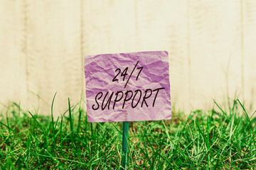 Conceptual hand writing showing 24 Or 7 Support. Concept meaning Giving assistance to service whole day and night No downtime Plain paper attached to stick and placed in the grassy land