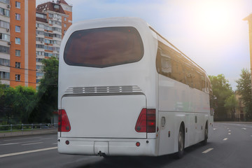 bus moves along a city street