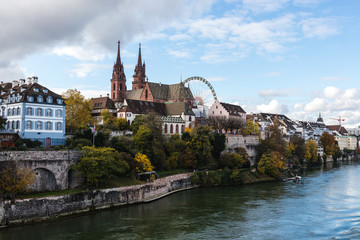 Fototapeta na wymiar Look at boardwalk in Basel over the Rhine river - city near Switzerland, Germany and France, included cathedrals two towers and russian wheel