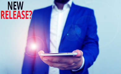 Word writing text New Release Question. Business photo showcasing asking about recent product or service newly unleashed Business concept with man holding mobile phone with touch screen
