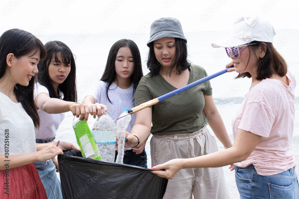 Wall mural group of volunteers cleaning sea beach