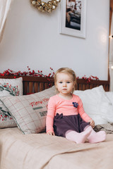 Fototapeta premium Infant adorable little cute girl playing at home in christmas morning