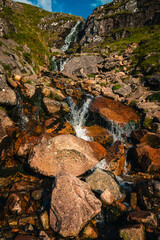 View on typical scotland watterfall near Ben Nevis, water jumping on the rocks during summer sunset