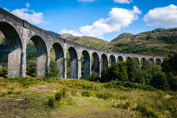 Fototapeta na wymiar View on famous Glenfinnan viaduct with red Jacobi train, Scotland