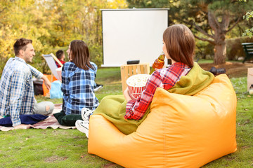 Friends watching movie in outdoor cinema