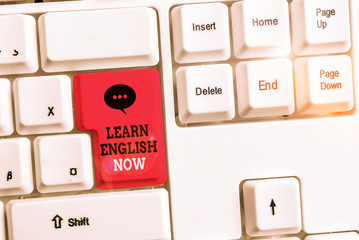 Text sign showing Learn English Now. Business photo showcasing gain or acquire knowledge and skill of english language White pc keyboard with empty note paper above white background key copy space