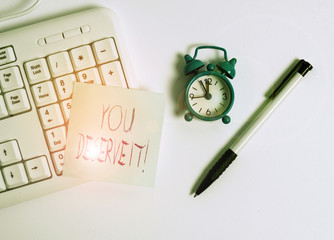 Text sign showing You Deserve It. Business photo text should have it because of their qualities or actions White pc keyboard with empty note paper above white background