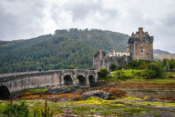 Fototapeta premium Magnificent Eilean Donan castle during cloudy weather at low tide