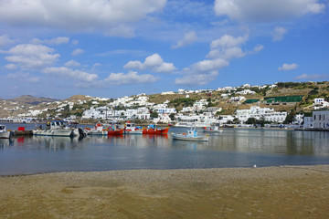 Picturesque port and main village of Mykonos island with traditional fishing boats and beautiful...