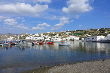Fototapeta na wymiar Picturesque port and main village of Mykonos island with traditional fishing boats and beautiful sunny weather, Cyclades, Greece