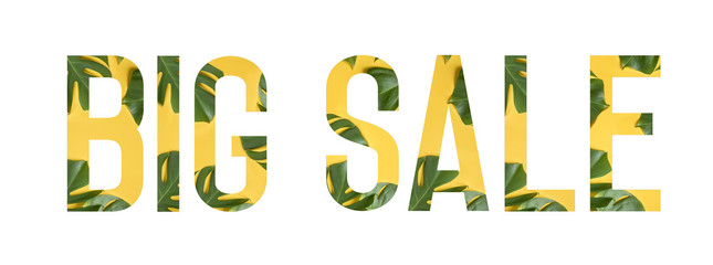 Tropical flower font Alphabet BIG SALE made of Real alive flowers monstera on yellow background with paper cut shape of letter. Collection of flora font for your unique decoration in summer