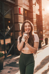 Beautiful smiling woman posing for the camera with coffee in the city.