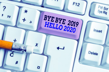 Word writing text Bye Bye 2019 Hello 2020. Business photo showcasing Starting new year Motivational message 2019 is over White pc keyboard with empty note paper above white background key copy space © A