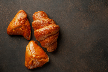 croissant and buns on a stone background with copy space for your text