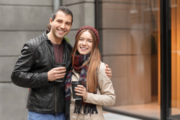 Happy couple walking in autumn city