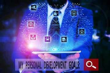 Conceptual hand writing showing My Personal Development Goals. Concept meaning Desires Wishes Career Business planning Male wear formal work suit presenting presentation smart device