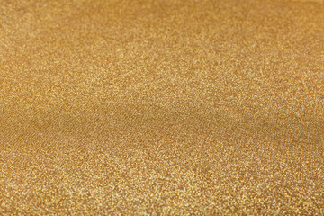Abstract blurred gold sparkle bakground.