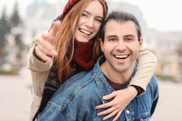 Happy couple having fun in autumn city