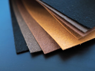 close up multi-colored sheets of felt, shades of brown of background