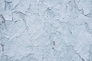 Old wall with cracked paint texture. Background of peeling white stucco.