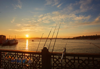 Silhouettes of fishermen fishing on Galata Bridge to relax and enjoy their hobby in Istanbul