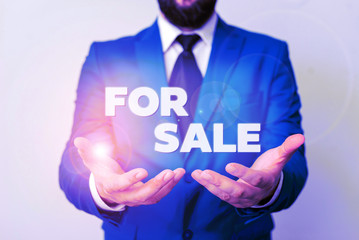 Text sign showing For Sale. Business photo showcasing putting property house vehicle available to be bought by others Man with opened hands in fron of the table. Mobile phone and notes on the table