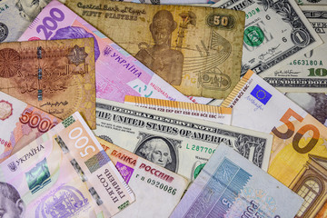 Multi currency background. Euro, american dollars, ukrainian hryvnias, egyptian pounds, russian roubles