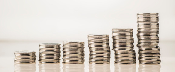 stack of coins isolated on white background incomes are rising