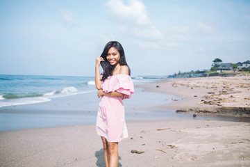 Young Indonesian woman smiling on coastline