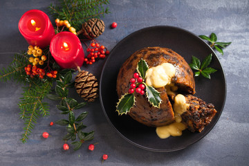 Christmas pudding decorated with sprig of holly. Cristmas decorations. View from above, top
