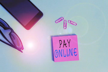 Conceptual hand writing showing Pay Online. Concept meaning buy products or service using credit card on any website Eyeglasses colored sticky note smartphone pastel background