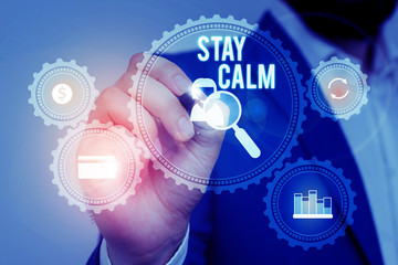 Text sign showing Stay Calm. Business photo showcasing Maintain in a state of motion smoothly even under pressure Male human wear formal work suit presenting presentation using smart device