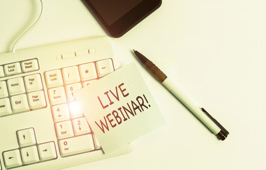 Handwriting text writing Live Webinar. Conceptual photo presentation lecture or seminar transmitted over Web White pc keyboard with empty note paper above white background