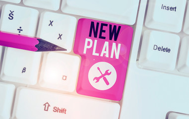 Text sign showing New Plan. Business photo showcasing Start of a detailed proposal of doing or achieving something White pc keyboard with empty note paper above white background key copy space