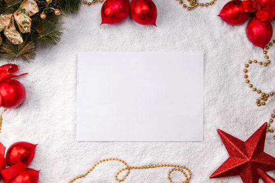 Sheet of white paper on snow christmas background top view mock up