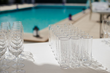 Champagne glass with dining set prepare dinner on table by the swimming pool