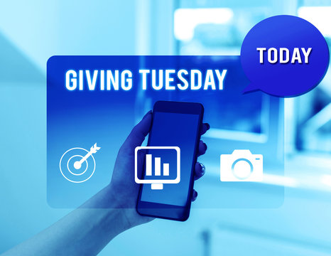 Text sign showing Giving Tuesday. Business photo text international day of charitable giving Hashtag activism woman icons smartphone speech bubble office supplies technological device