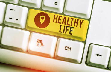 Text sign showing Healthy Life. Business photo showcasing one that helps to keep and improve showing s is health or condition White pc keyboard with empty note paper above white background key copy