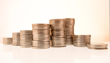  columns of coins on white and colored backgrounds close-up