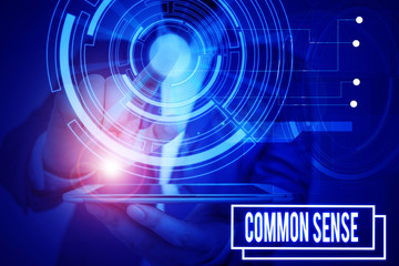 Text sign showing Common Sense. Business photo showcasing having good sense and sound judgment in practical matters Male human wear formal work suit presenting presentation using smart device