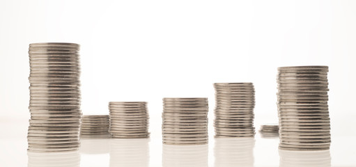  columns of coins on white and colored backgrounds close-up