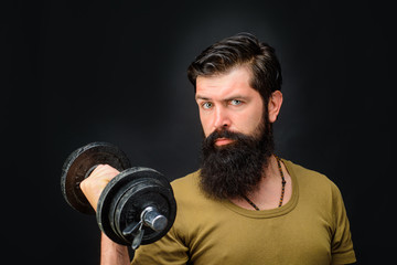 Fitness. Sportsman with dumbbells training. Sportsman making weightlifting. Lose weight. Strong man training with dumbbells. Bearded man exercise with dumbbells. Handsome athlete man with dumbbells.