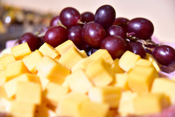 plate with ham cheese grapes antipasto pepperoni