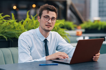 businessman working on laptop in park