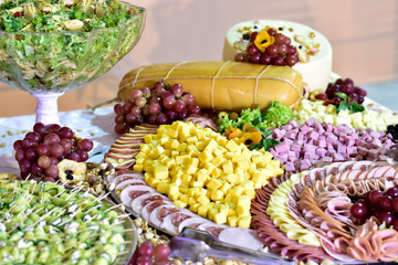 plate with ham cheese grapes antipasto pepperoni