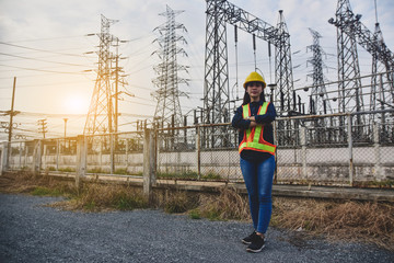 Women Engineering standing communication at power plant  electrical system background